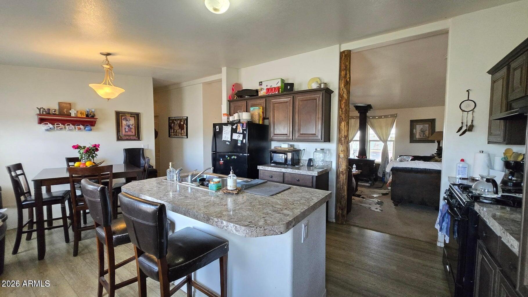 8495 Antelope Run Road Ash Fork, AZ 86320 - Photo 13 of 40 a view of a dining room with furniture and wooden floor