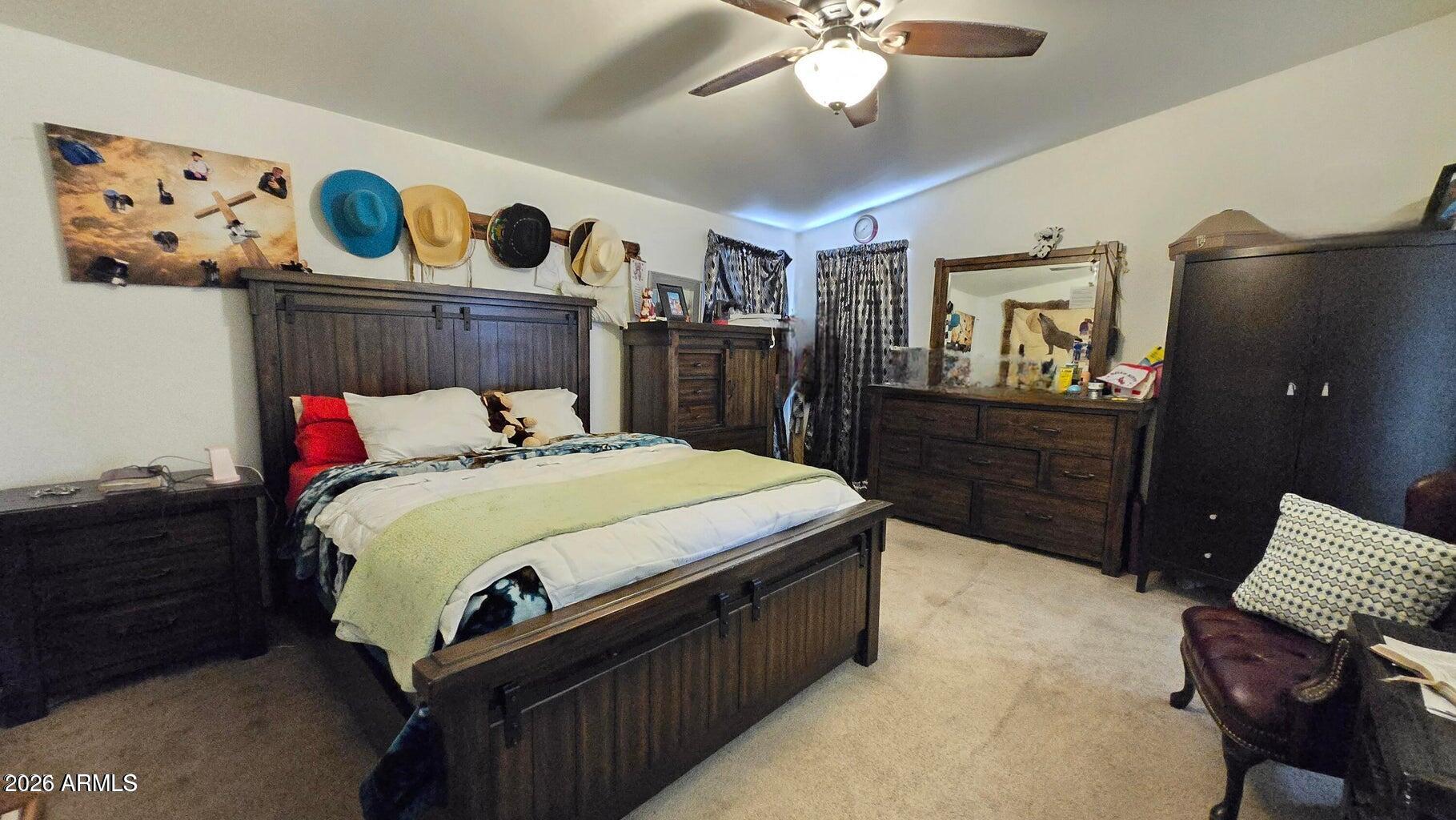 8495 Antelope Run Road Ash Fork, AZ 86320 - Photo 16 of 40 a bedroom with a bed and cabinets