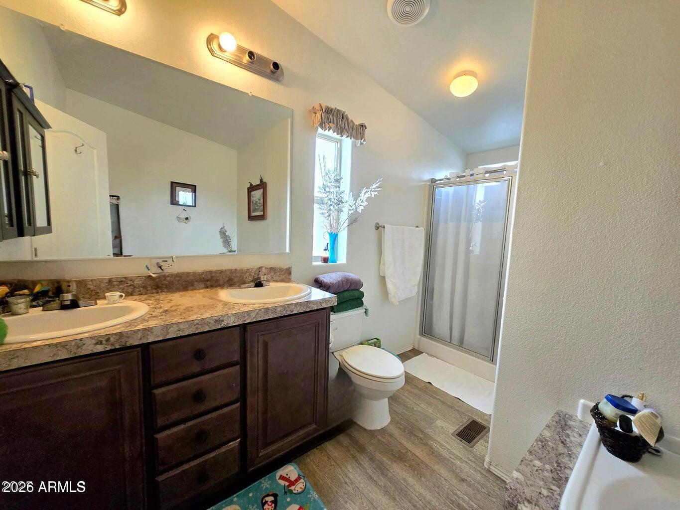 8495 Antelope Run Road Ash Fork, AZ 86320 - Photo 19 of 40 a bathroom with a granite countertop sink toilet mirror and vanity