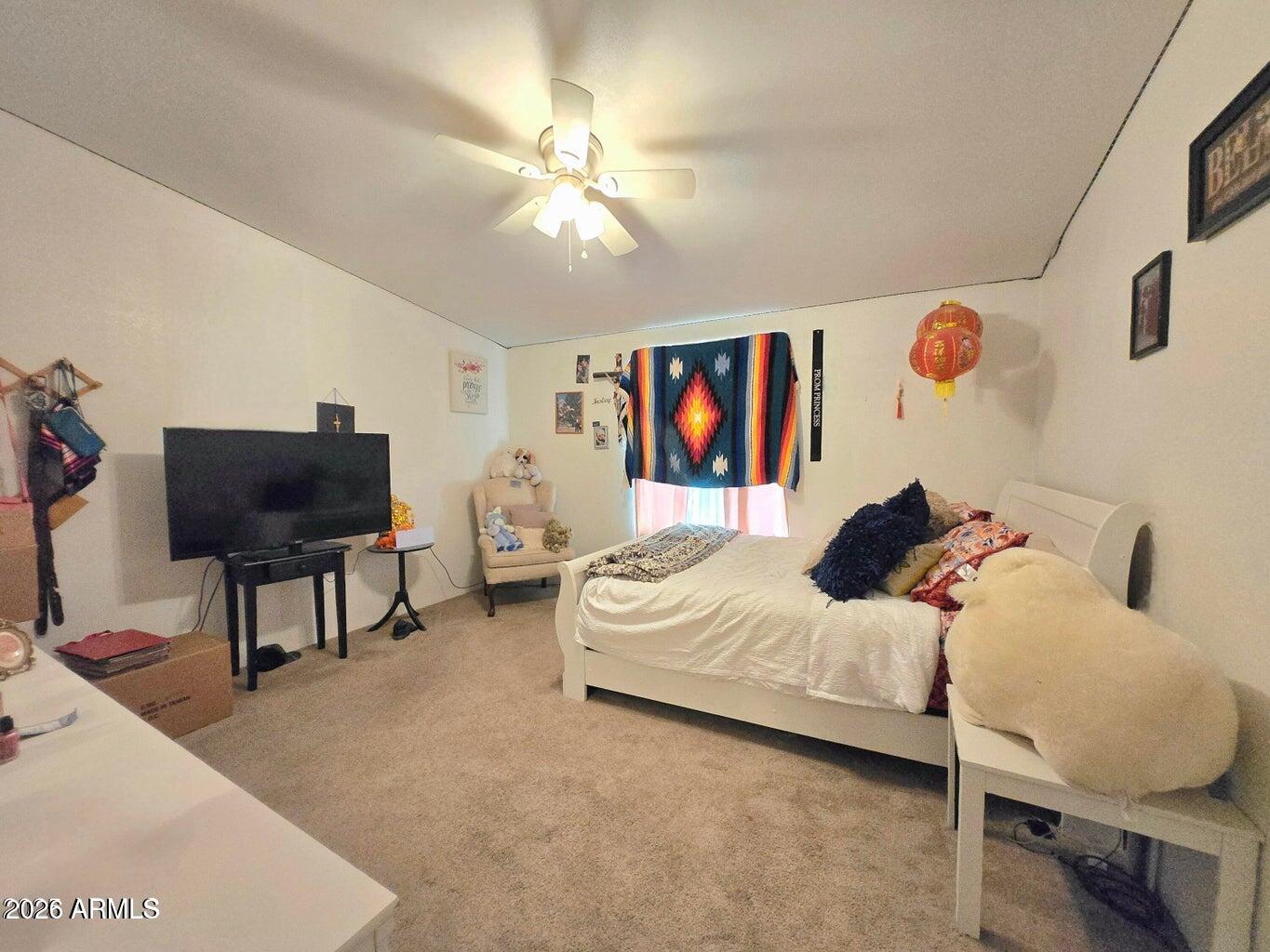 8495 Antelope Run Road Ash Fork, AZ 86320 - Photo 20 of 40 a bedroom with a bed and a chandelier