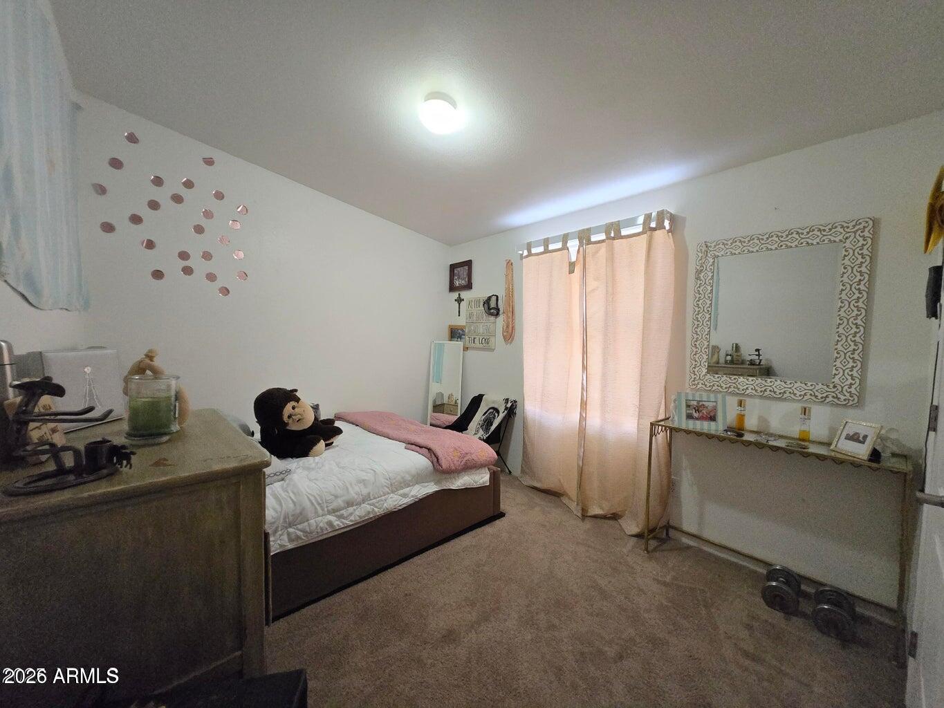 8495 Antelope Run Road Ash Fork, AZ 86320 - Photo 22 of 40 a bedroom with a bed and a table