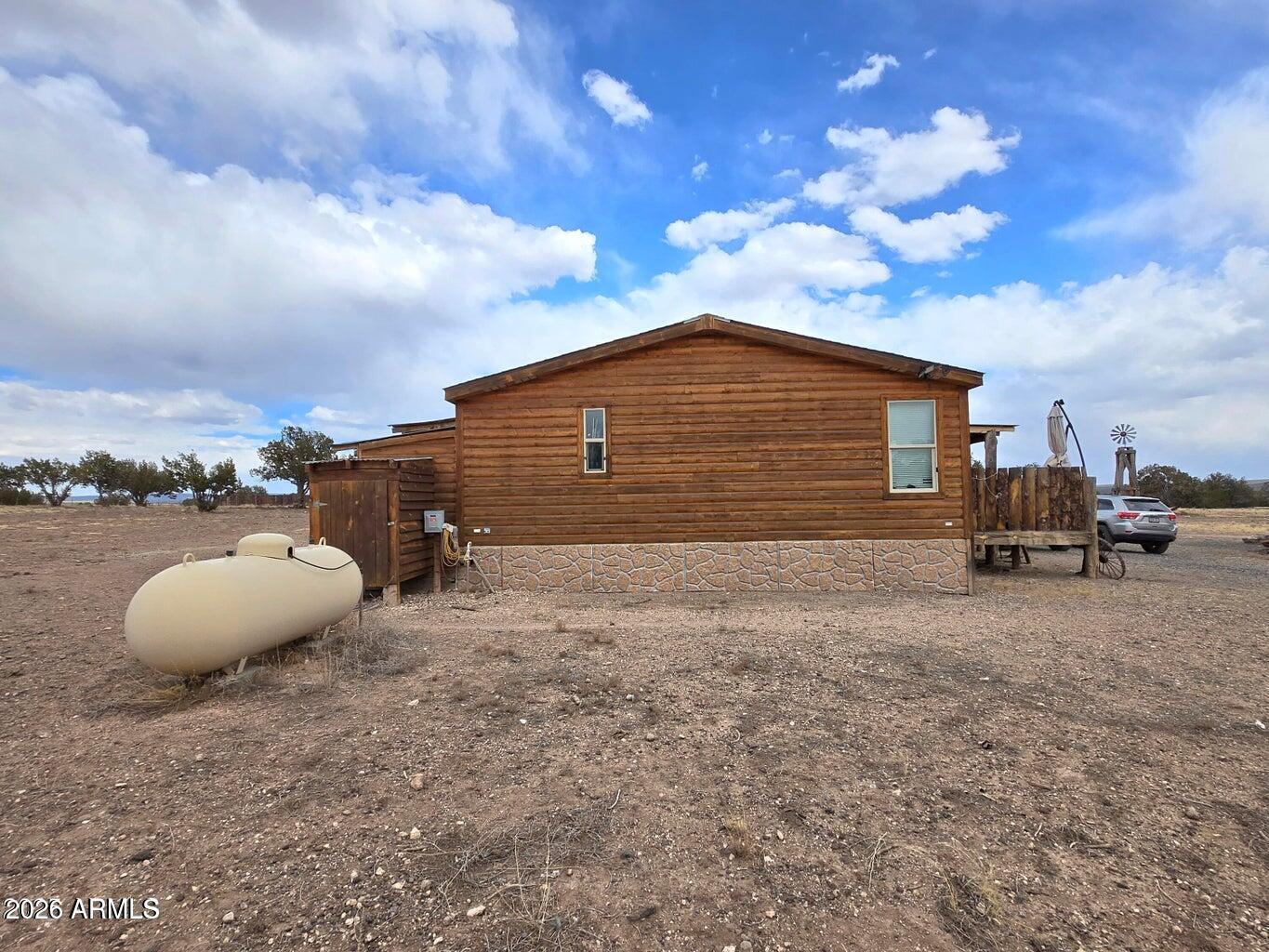 8495 Antelope Run Road Ash Fork, AZ 86320 - Photo 3 of 40 a backyard of a house with table and chairs