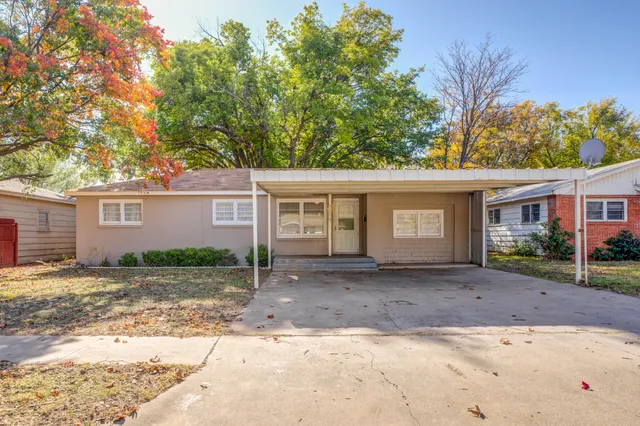 a front view of a house with a yard and a garage