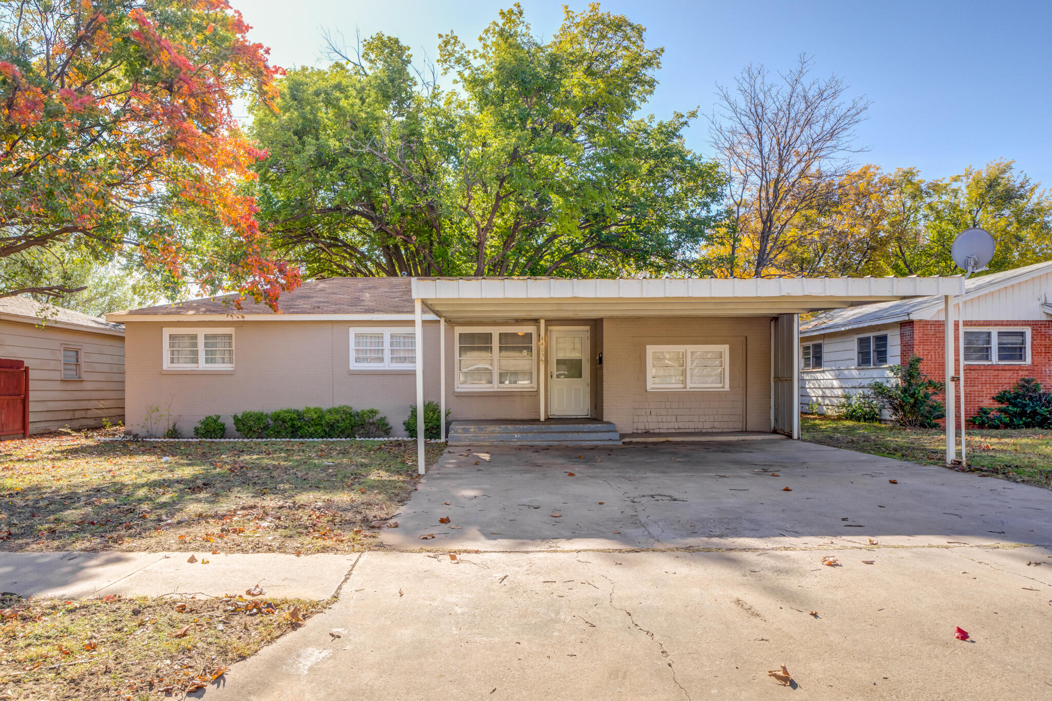 a front view of a house with a yard and a garage