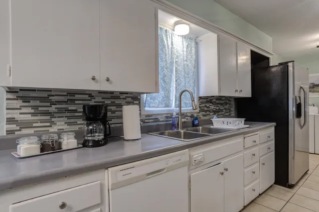 a kitchen with appliances a sink and cabinets