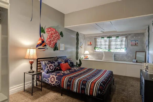 a bedroom with a bed and window