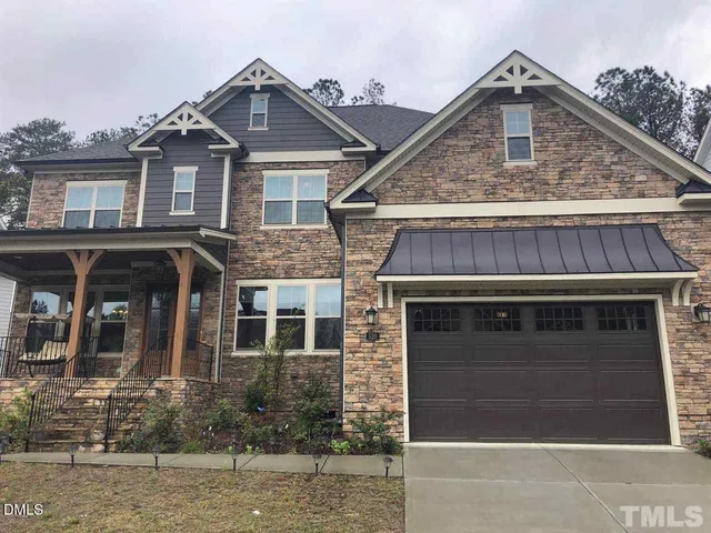 a front view of a house with a garage