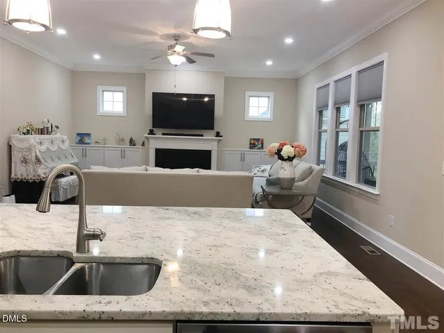 a kitchen with a stove a sink and a microwave with the couches