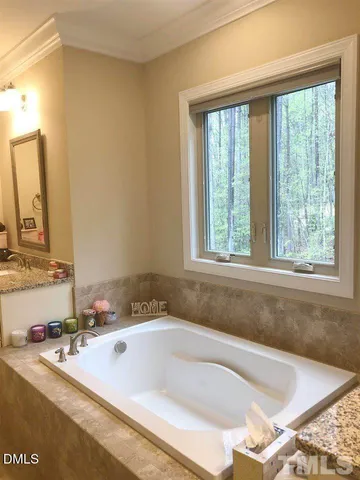 a bath tub sitting in a bathroom next to a window