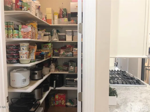 a room with water heater and wooden floor