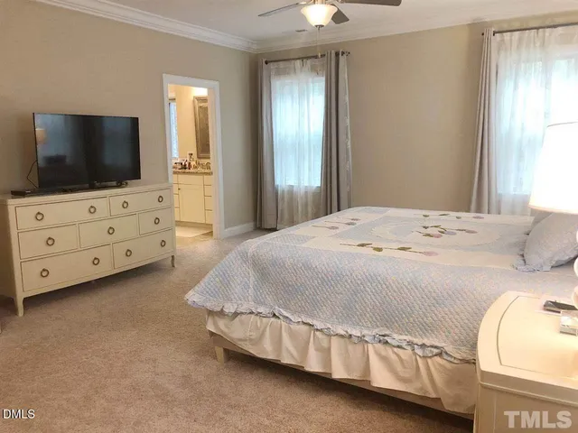 a bedroom with a bed and flat screen tv