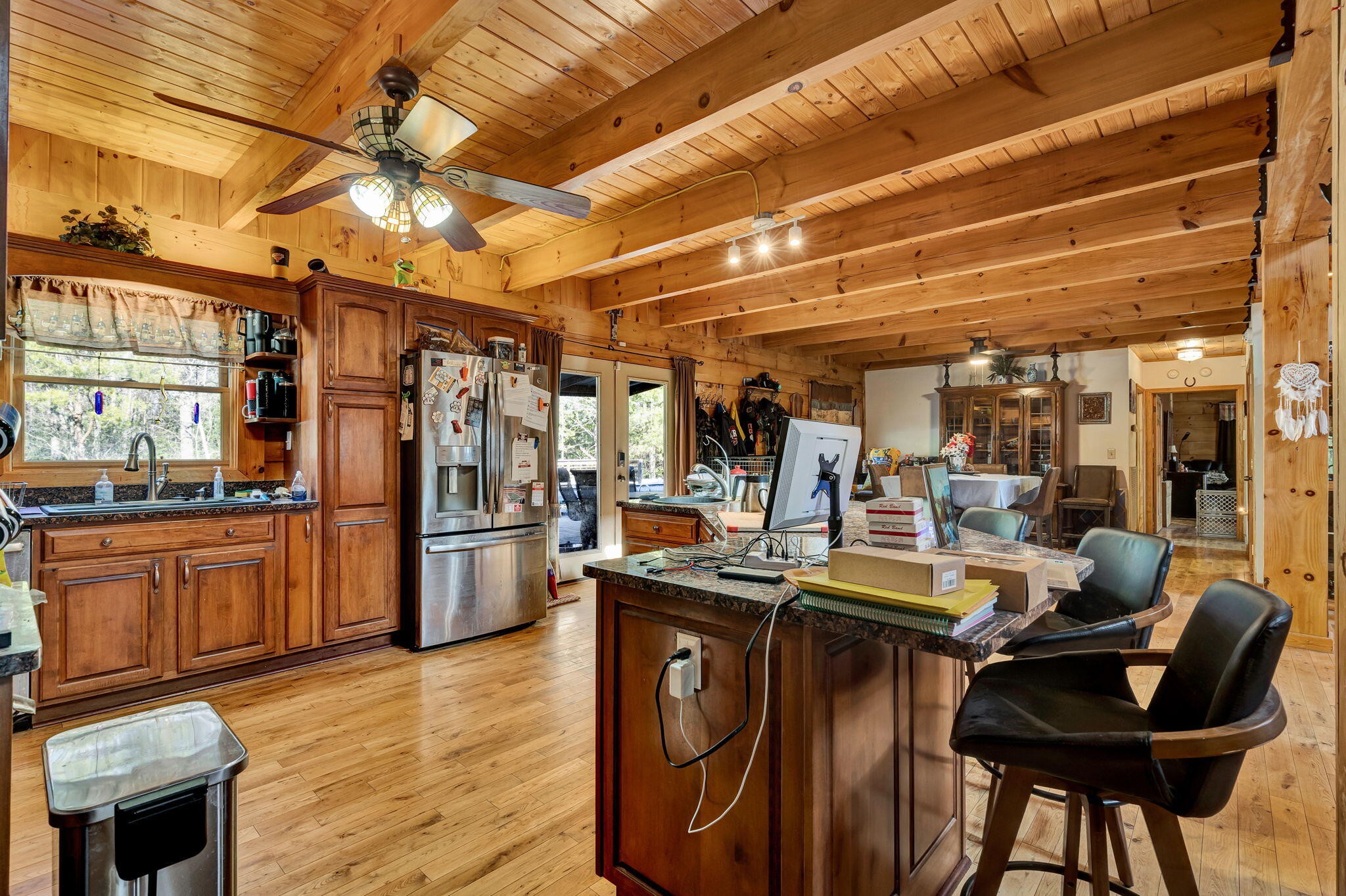 180 McJunkin Road Tellico Plains, TN 37385 - Photo 11 of 60 a view of a kitchen with refrigerator and wooden cabinets