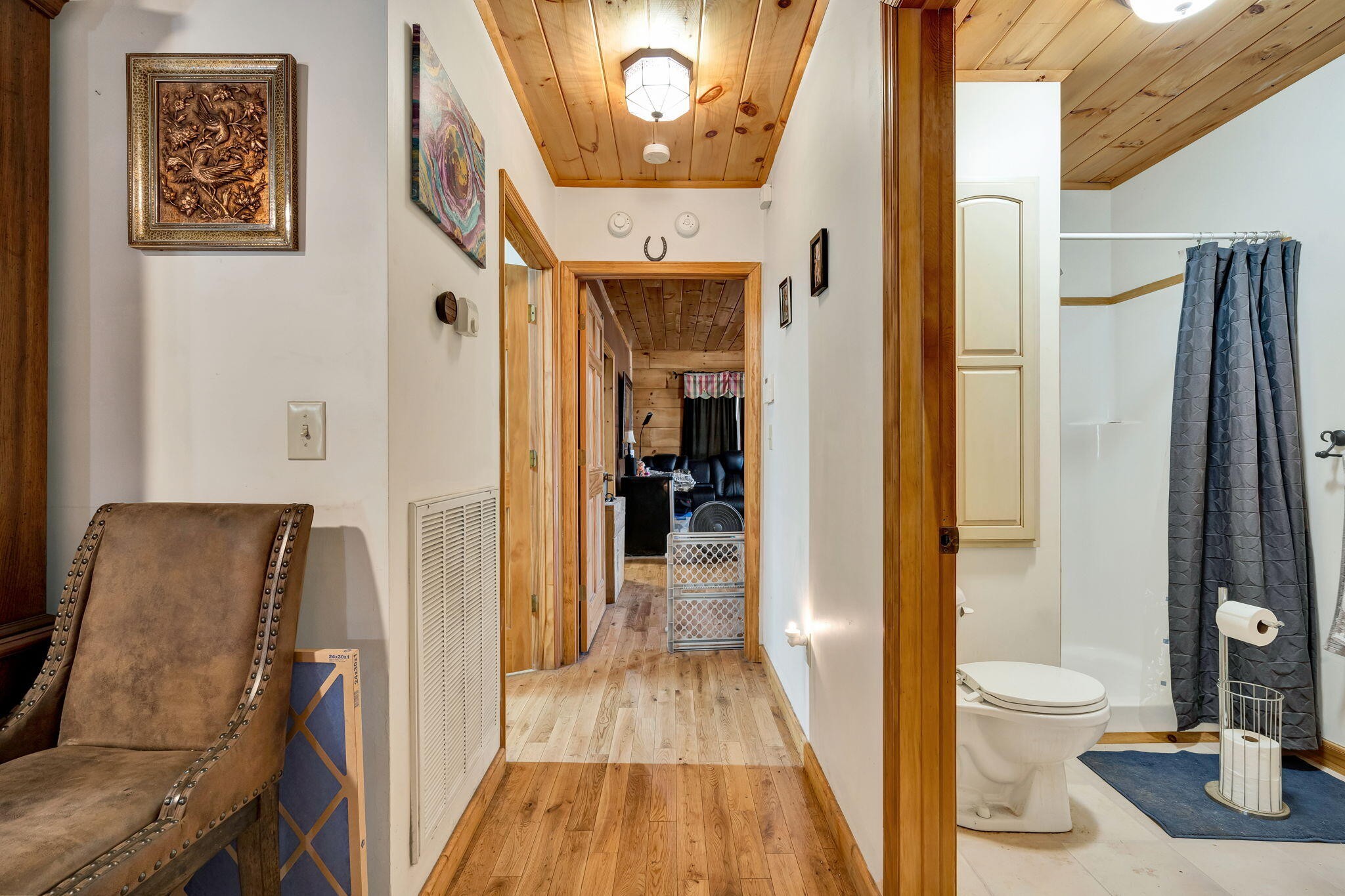 180 McJunkin Road Tellico Plains, TN 37385 - Photo 22 of 60 a view of a hallway with wooden floor and a bathroom