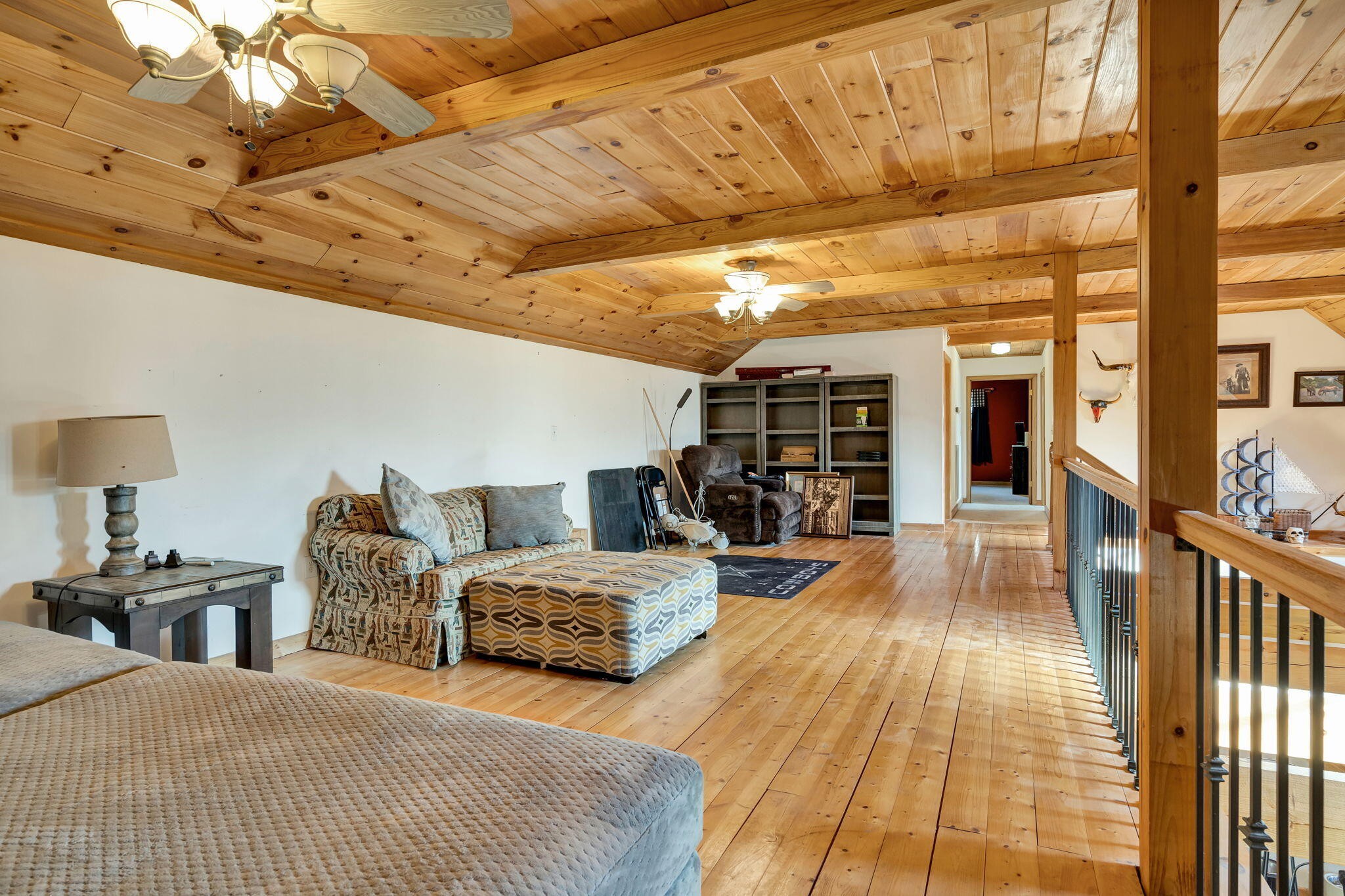 180 McJunkin Road Tellico Plains, TN 37385 - Photo 34 of 60 a bedroom with a large bed and a chandelier