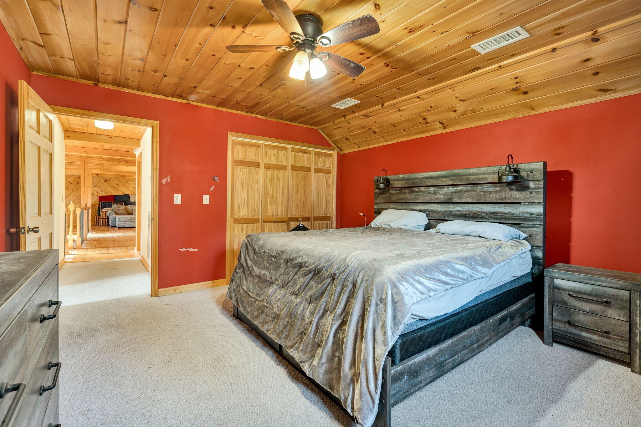 180 McJunkin Road Tellico Plains, TN 37385 - Photo 40 of 60 a bedroom with a bed and a chandelier