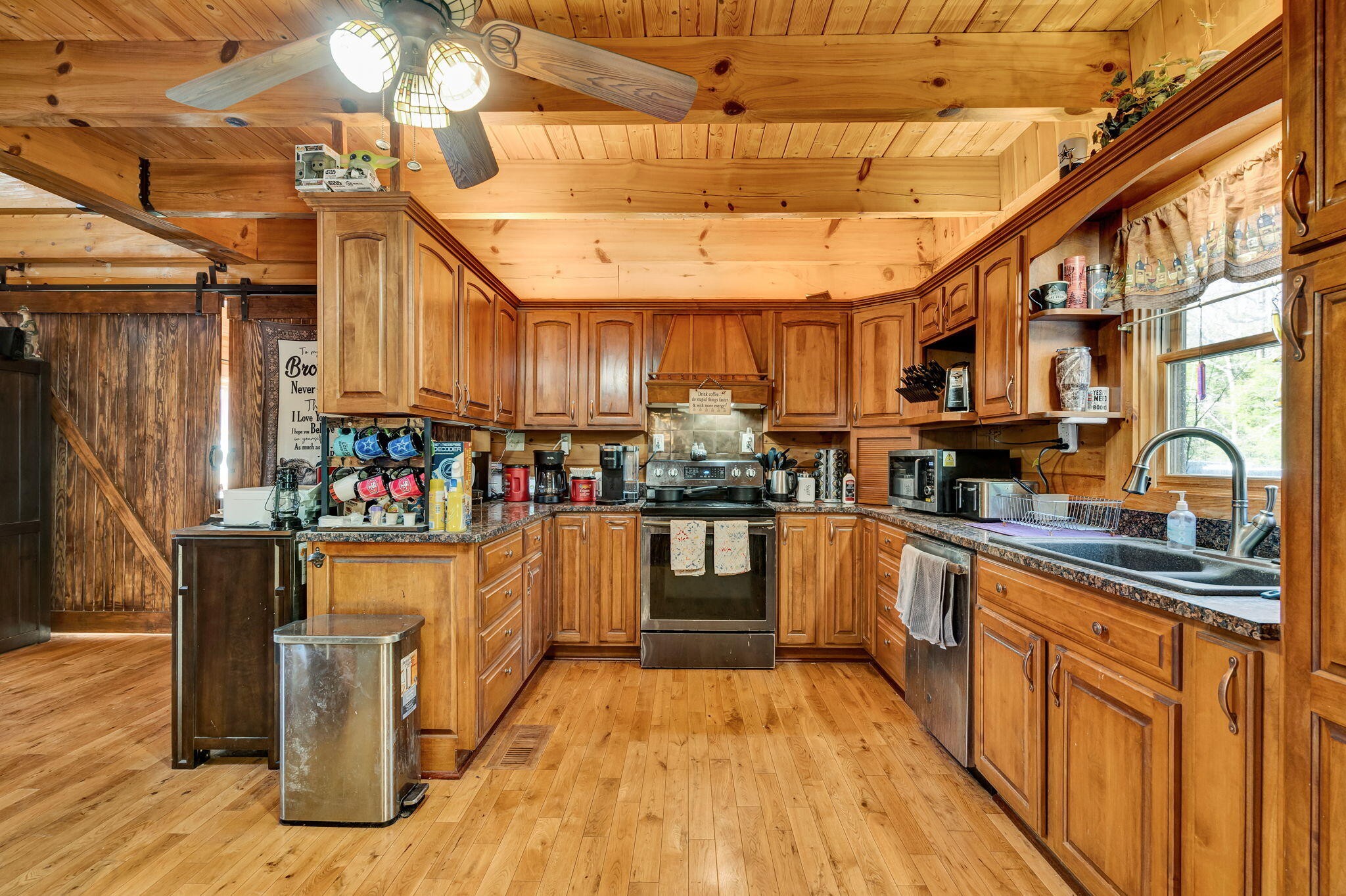 180 McJunkin Road Tellico Plains, TN 37385 - Photo 8 of 60 a kitchen with stainless steel appliances granite countertop a sink and cabinets