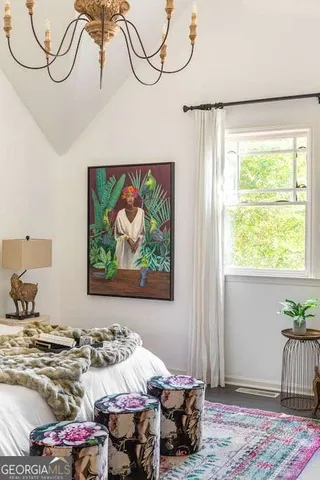 a view of a hallway with wooden floor and a bathroom
