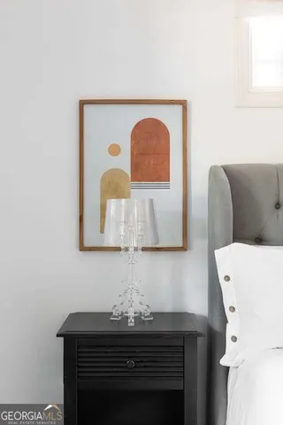 a living room with a table a couch and chandelier