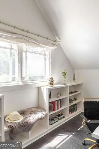 a living room with furniture a chandelier and a large window