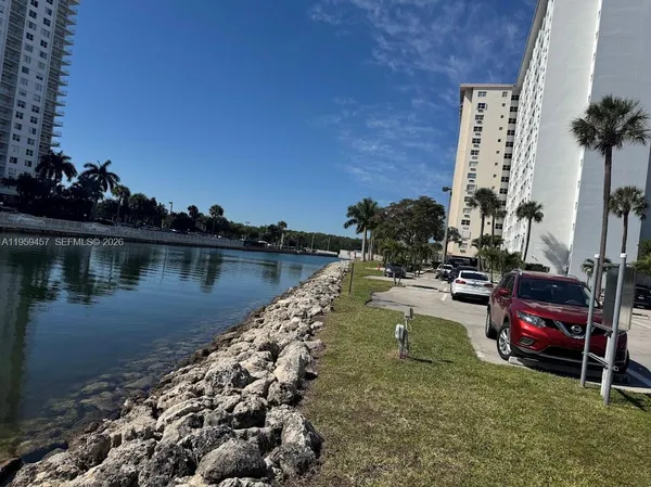 a view of a lake with a cars parked