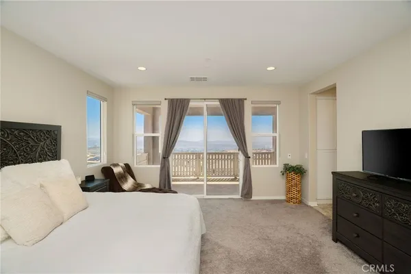 a bedroom with a bed and a television