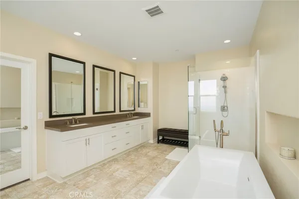 a bathroom with a tub a toilet and a shower