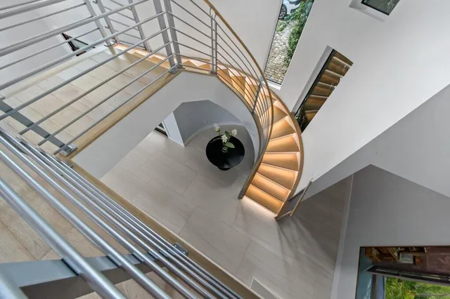 a kitchen with stainless steel appliances kitchen island granite countertop a stove and a sink