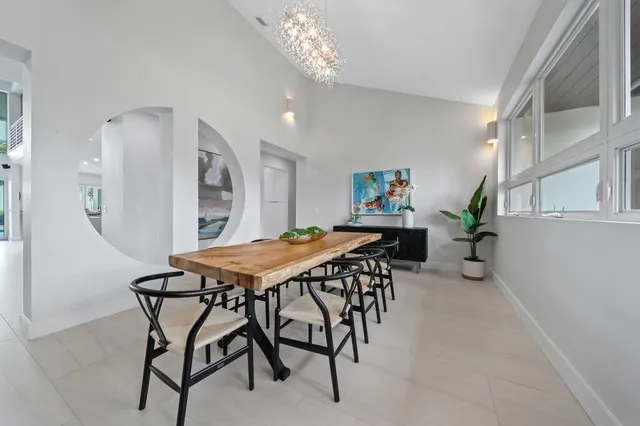 a living room with furniture a flat screen tv and a large window