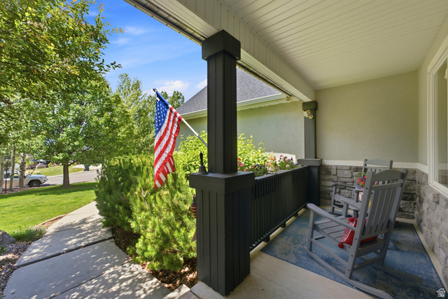 5196 Rodeo Circle Oakley, UT 84055 - Photo 4 of 57 Covered front porch featuring stone veneer accents and a painted concrete floor