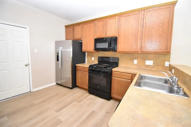 a kitchen with a refrigerator sink and stove