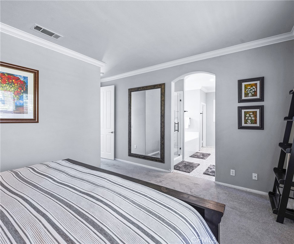 45 Coriander Irvine, CA 92603 - Photo 19 of 64 a bedroom with a bed and a painting