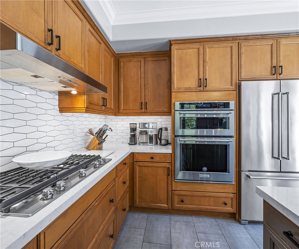 45 Coriander Irvine, CA 92603 - Photo 37 of 64 a kitchen with stainless steel appliances granite countertop a stove and a refrigerator