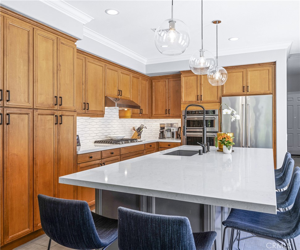 45 Coriander Irvine, CA 92603 - Photo 9 of 64 a kitchen with a table chairs microwave and cabinets