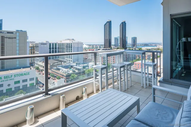 a view of roof deck with two chairs and a table