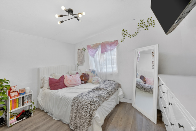 160 Cushing Way Layton, UT 84041 - Photo 21 of 23 Interior room featuring light-toned wood-finish flooring, white walls, and a contemporary ceiling light fixture