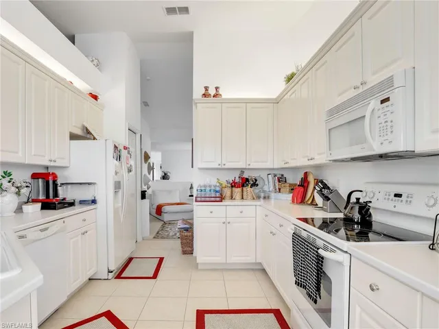 a large bed sitting in a bedroom next to a window