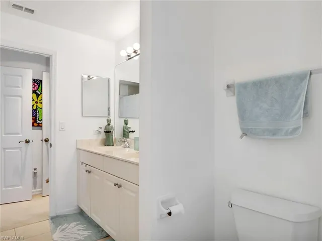 a bedroom with two beds and a chandelier