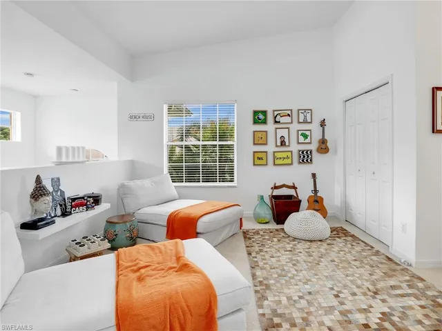 a bedroom with two beds and a large window