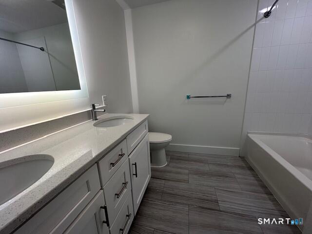 111 Morgan Street, Unit TH5 Stamford, CT 06905 - Photo 13 of 23 a bathroom with a granite countertop sink a toilet and bathtub