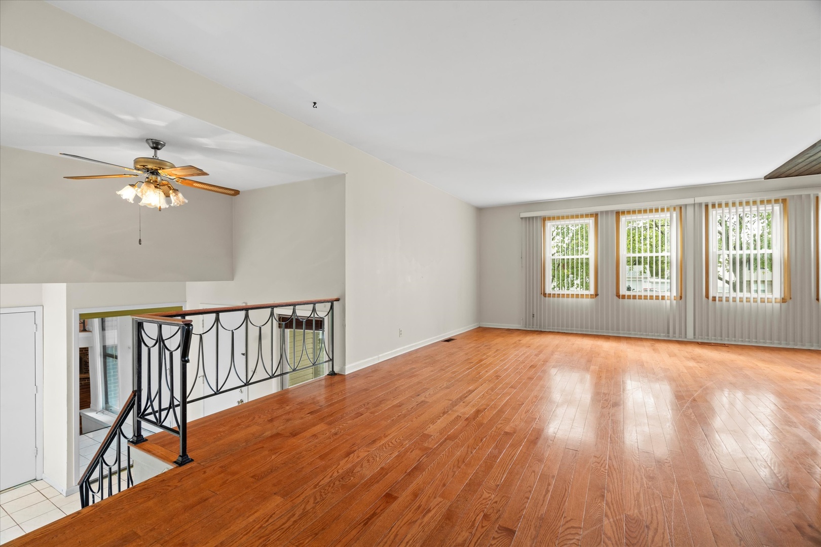 446 Rockhurst Road Bolingbrook, IL 60440 - Photo 4 of 32 a view of an empty room with a window and wooden floor