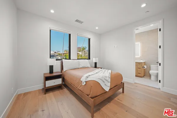 a bedroom with a bed and a table