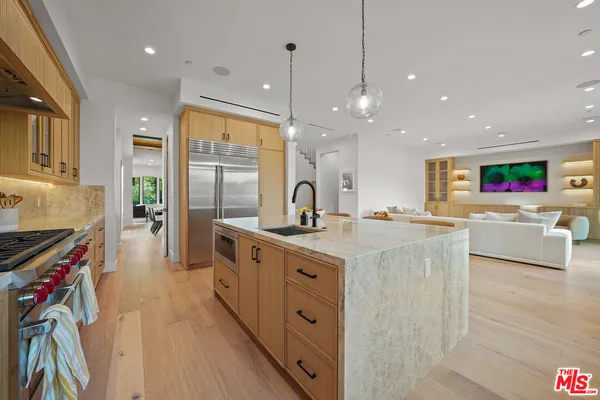 a kitchen with counter top space sink stove and refrigerator
