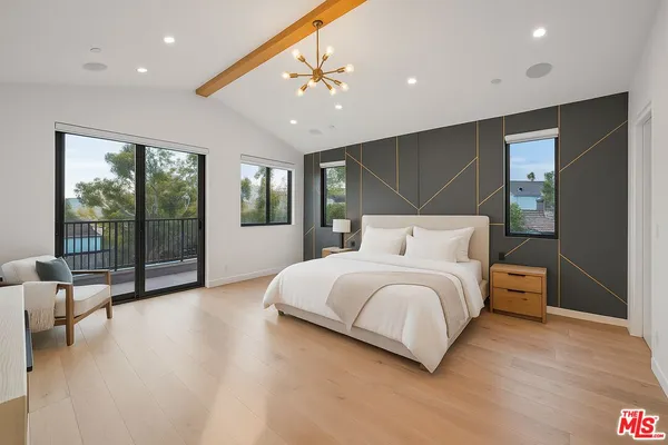 a spacious bedroom with a large bed and a large window