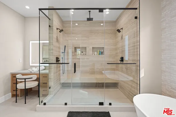 a bathroom with a bathtub and a shower
