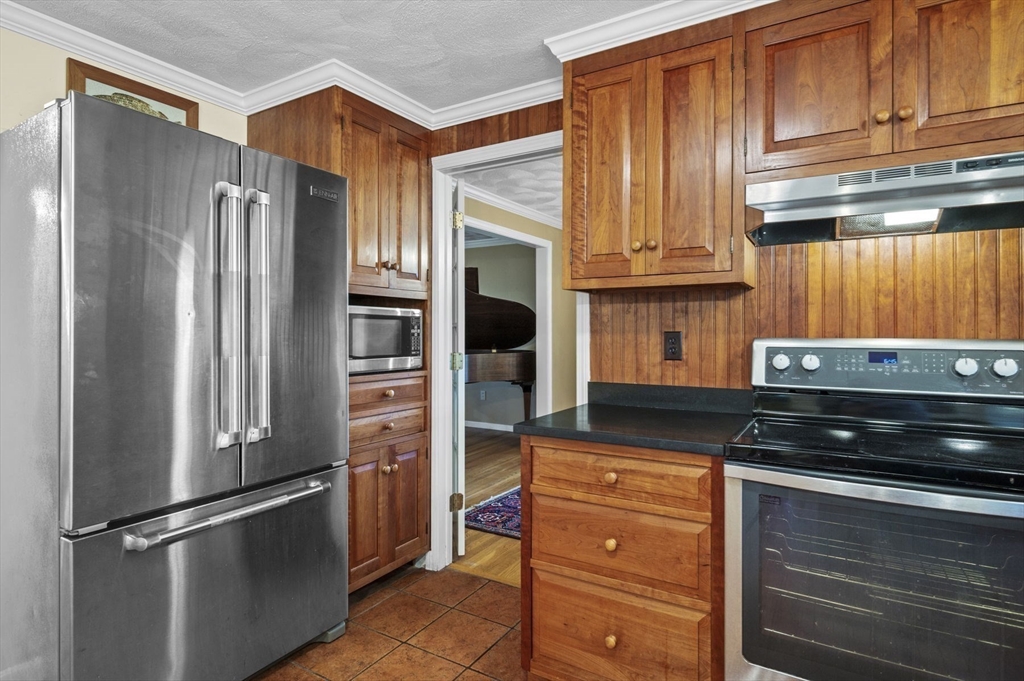 265 B Washington Street Boxford, MA 01921 - Photo 11 of 42 a kitchen with stainless steel appliances granite countertop a refrigerator and a stove top oven