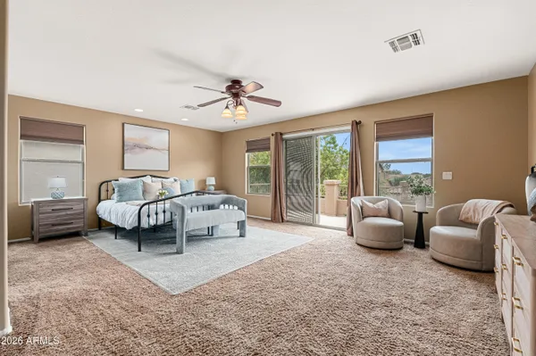 a bedroom with furniture and a large window