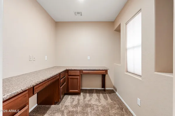 a view of storage and utility room with window