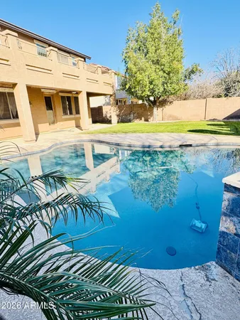 a view of a backyard with plants and lake view