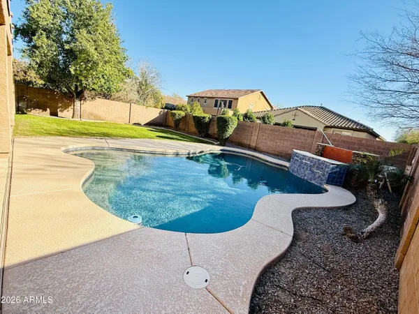 a view of a swimming pool with a yard