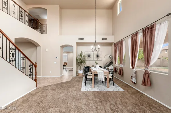 a dining room with furniture entryway and wooden floor